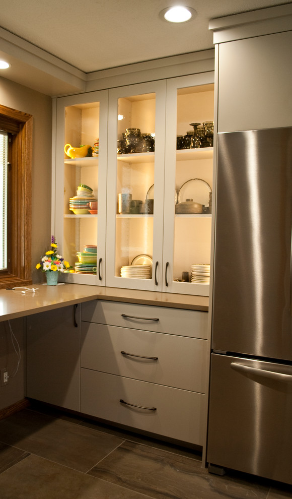 Mid-sized transitional u-shaped eat-in kitchen photo with an undermount sink, flat-panel cabinets, gray cabinets, brown backsplash, wood backsplash, stainless steel appliances and a peninsula