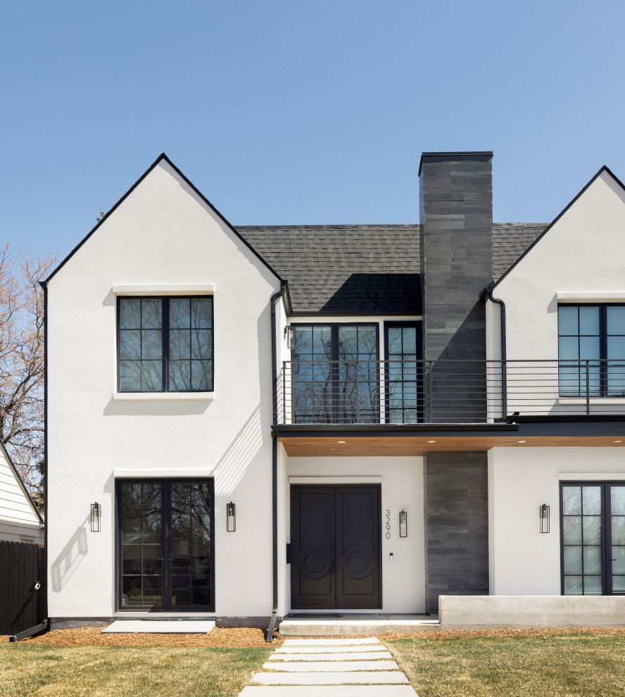 Large eclectic two-storey stucco white house exterior in Denver with a black roof.