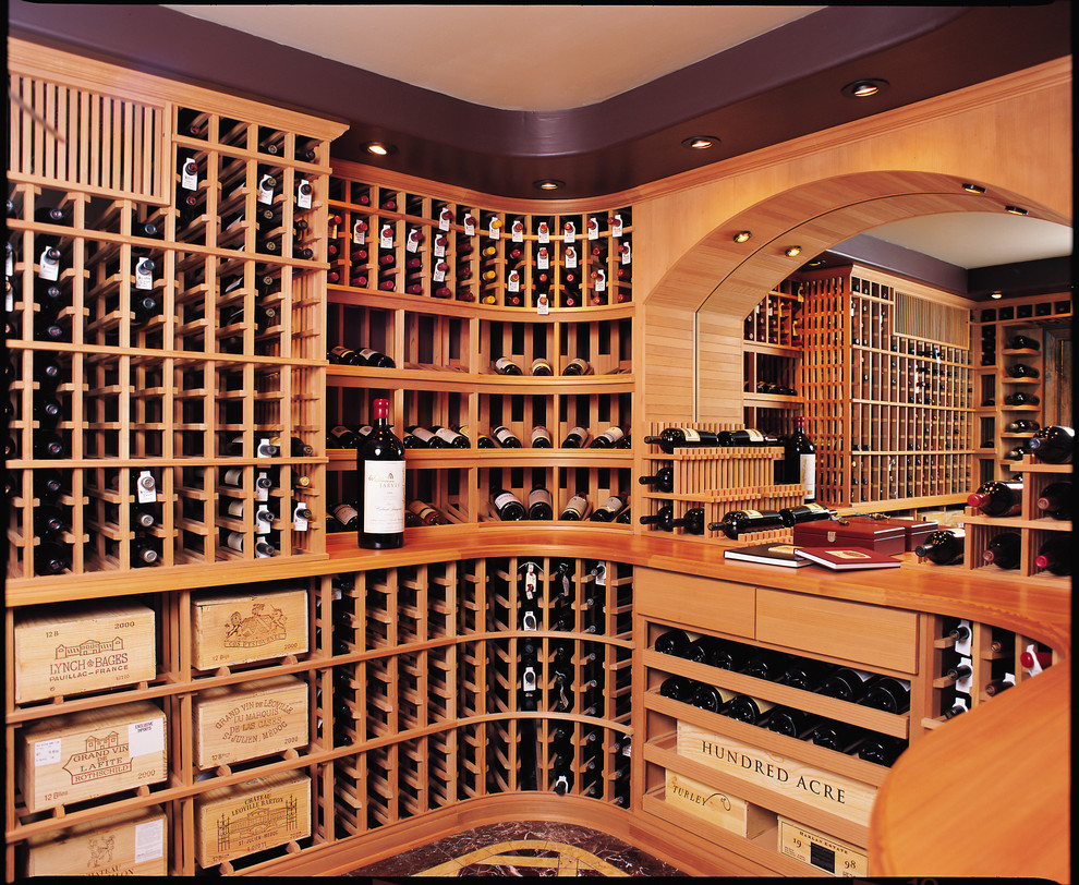 Wine cellar - large contemporary marble floor wine cellar idea in San Diego with storage racks