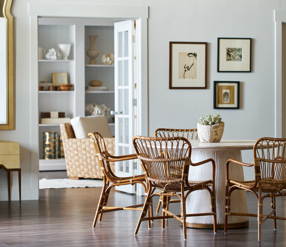 Inspiration for a transitional dining room in San Francisco with white walls and brown floor.