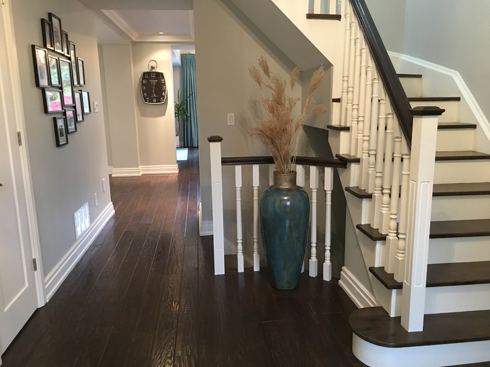 Inspiration for a mid-sized transitional dark wood floor foyer remodel in Toronto with gray walls