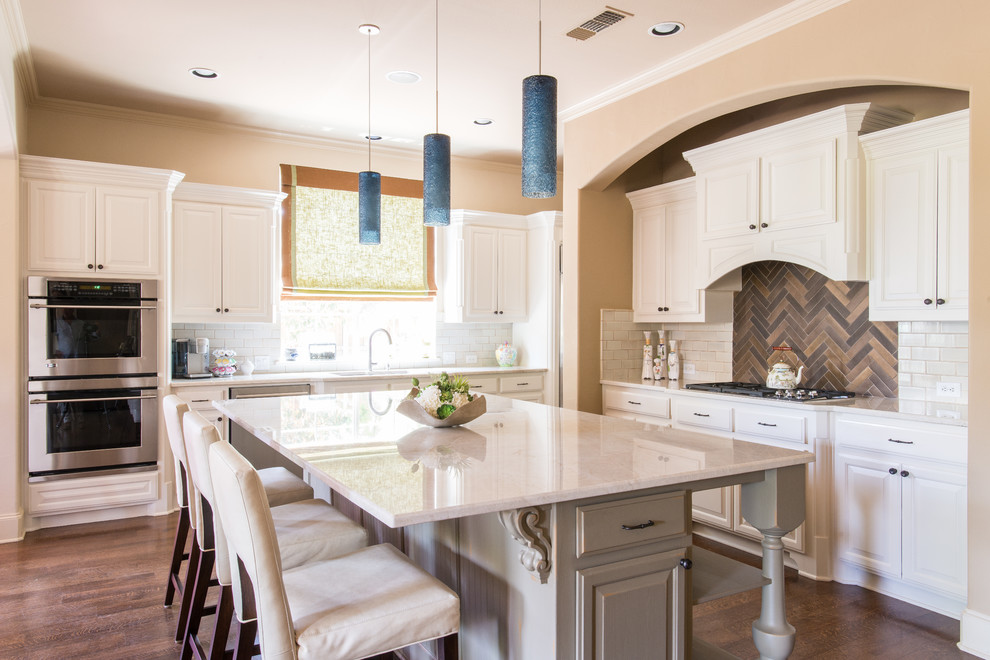 Design ideas for a mid-sized traditional l-shaped kitchen in Dallas with raised-panel cabinets, white cabinets, granite benchtops, stainless steel appliances, dark hardwood floors and with island.
