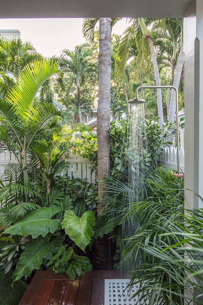 Small tropical side yard partial sun garden in Miami with a water feature.