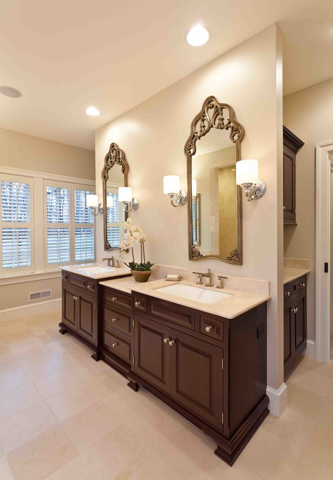 Photo of a large transitional master bathroom in Other with recessed-panel cabinets, dark wood cabinets, an alcove tub, an open shower, beige tile, ceramic tile, beige walls, ceramic floors, an undermount sink and limestone benchtops.