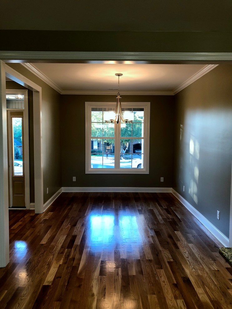 Mid-sized arts and crafts open plan dining in Charlotte with brown walls, medium hardwood floors, no fireplace and brown floor.