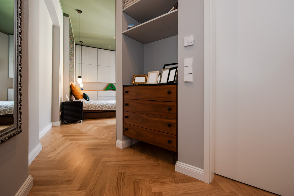 Mittelgroßes Eklektisches Hauptschlafzimmer mit grüner Wandfarbe, hellem Holzboden, braunem Boden und Tapetenwänden in Berlin