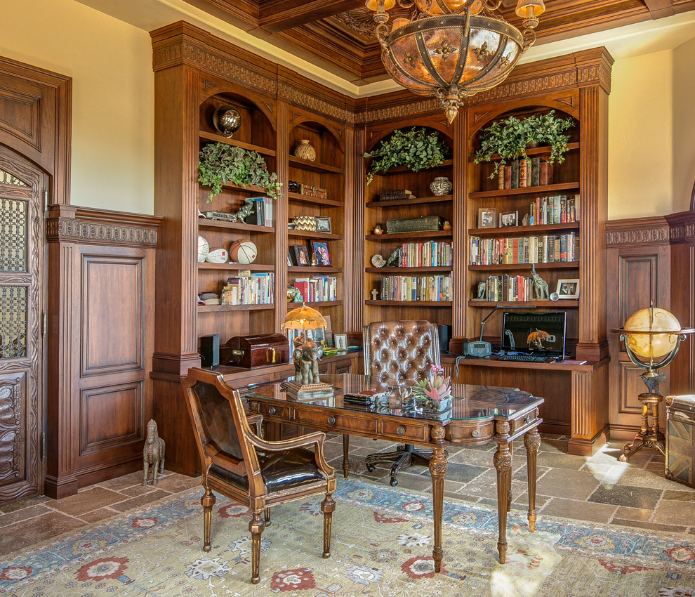 This is an example of a mediterranean study room in Phoenix with beige walls, slate floors and a freestanding desk.