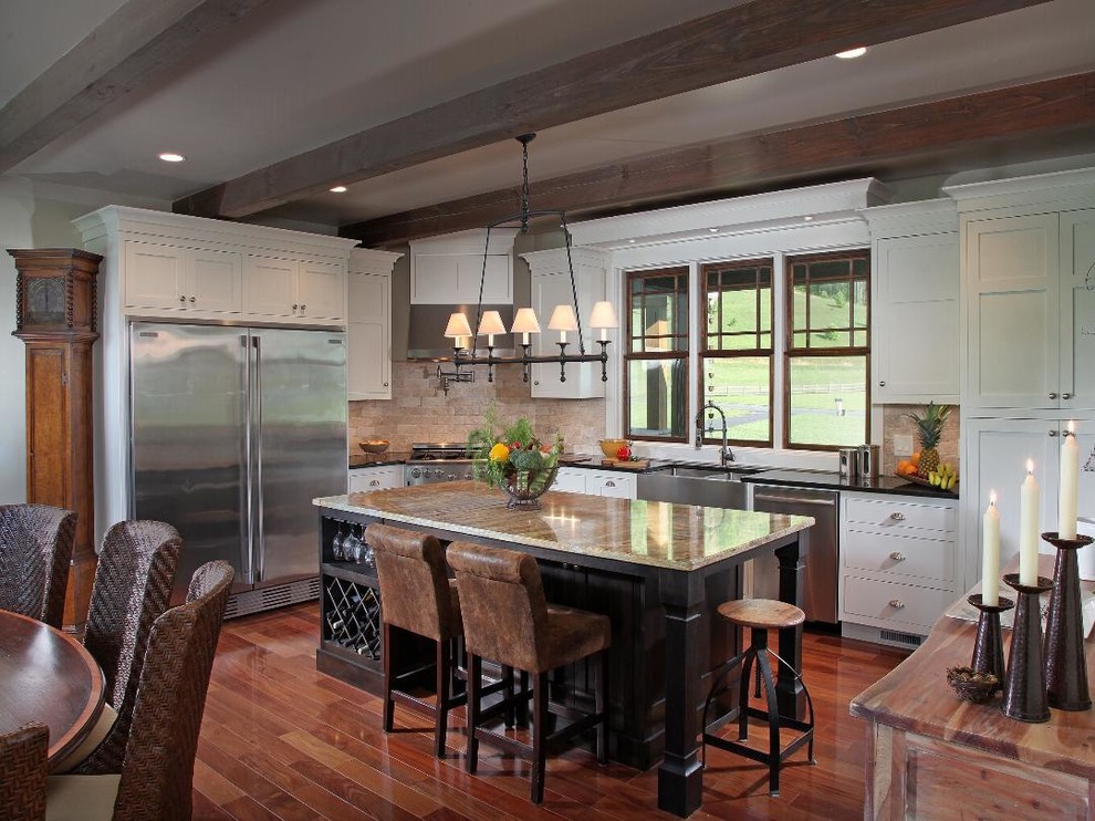 Mountain style kitchen photo in Atlanta with beige backsplash, stainless steel appliances and an island