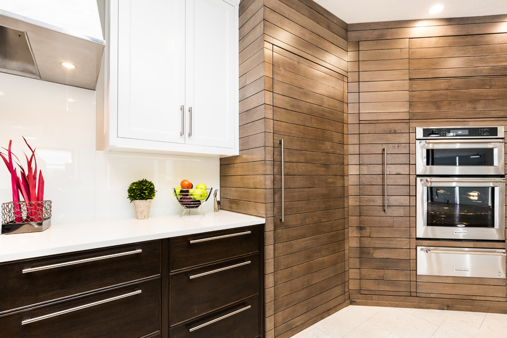 Huge transitional limestone floor kitchen photo in Albuquerque with an undermount sink, white backsplash, glass sheet backsplash and an island