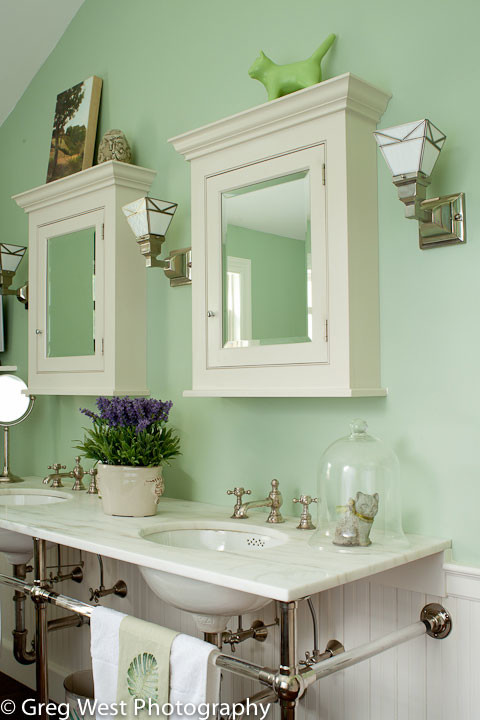 This is an example of a mid-sized transitional master bathroom in Manchester with green walls, recessed-panel cabinets, white cabinets, a claw-foot tub, a shower/bathtub combo, a two-piece toilet, medium hardwood floors, an undermount sink and marble benchtops.