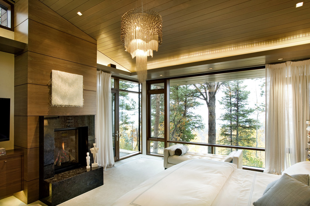 This is an example of a contemporary bedroom in Denver with a standard fireplace.