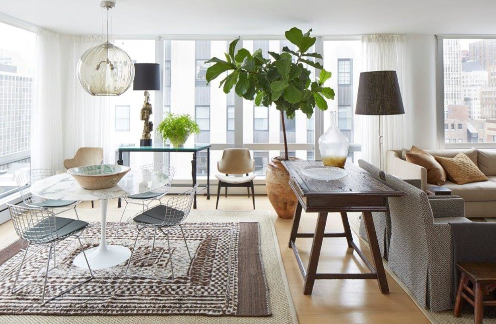Design ideas for a mid-sized scandinavian open plan dining in Chicago with white walls, light hardwood floors and beige floor.