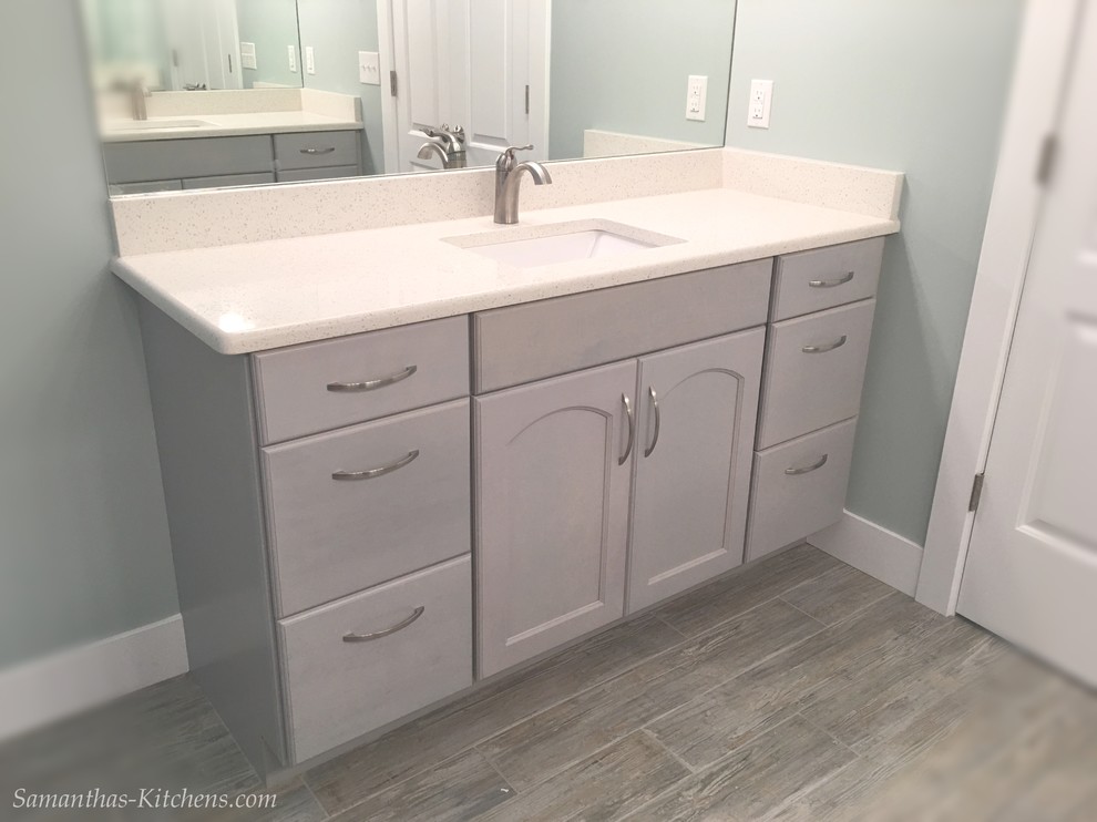 Home design - mid-sized transitional master porcelain tile home design idea with recessed-panel cabinets, gray cabinets, blue walls, an undermount sink and quartz countertops