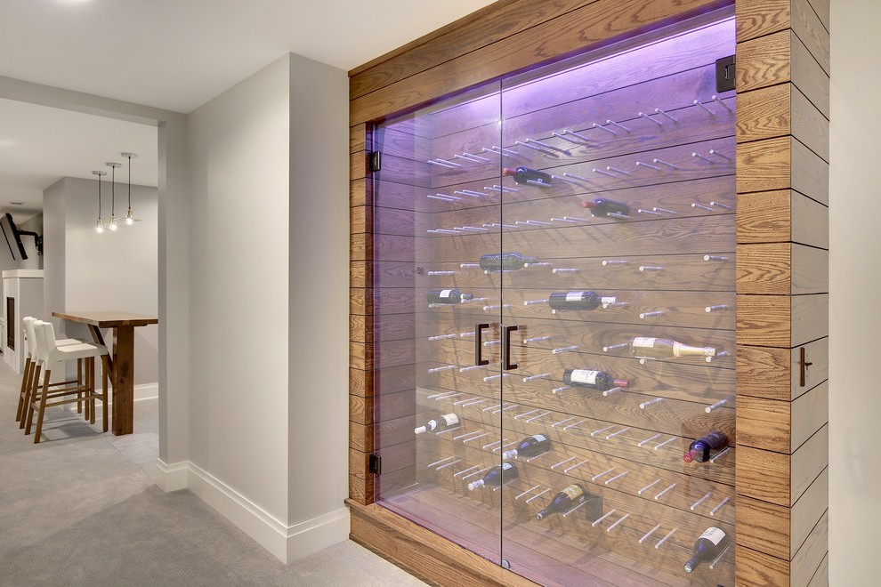 Inspiration for a traditional wine cellar in Minneapolis with medium hardwood floors, display racks and brown floor.