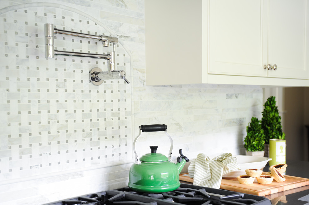 Example of a large transitional u-shaped dark wood floor home design design in Vancouver with a farmhouse sink, recessed-panel cabinets, white cabinets, glass countertops, white backsplash, stainless steel appliances and no island