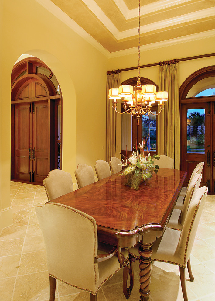 Inspiration for a large mediterranean separate dining room in Miami with beige walls, travertine floors and no fireplace.