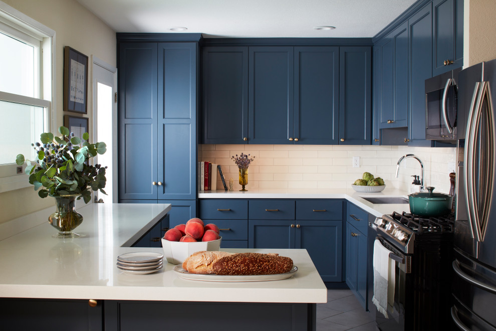 Inspiration for a medium sized classic kitchen in San Francisco with a submerged sink, recessed-panel cabinets, blue cabinets, quartz worktops, white splashback, metro tiled splashback, stainless steel appliances, porcelain flooring, grey floors and white worktops.