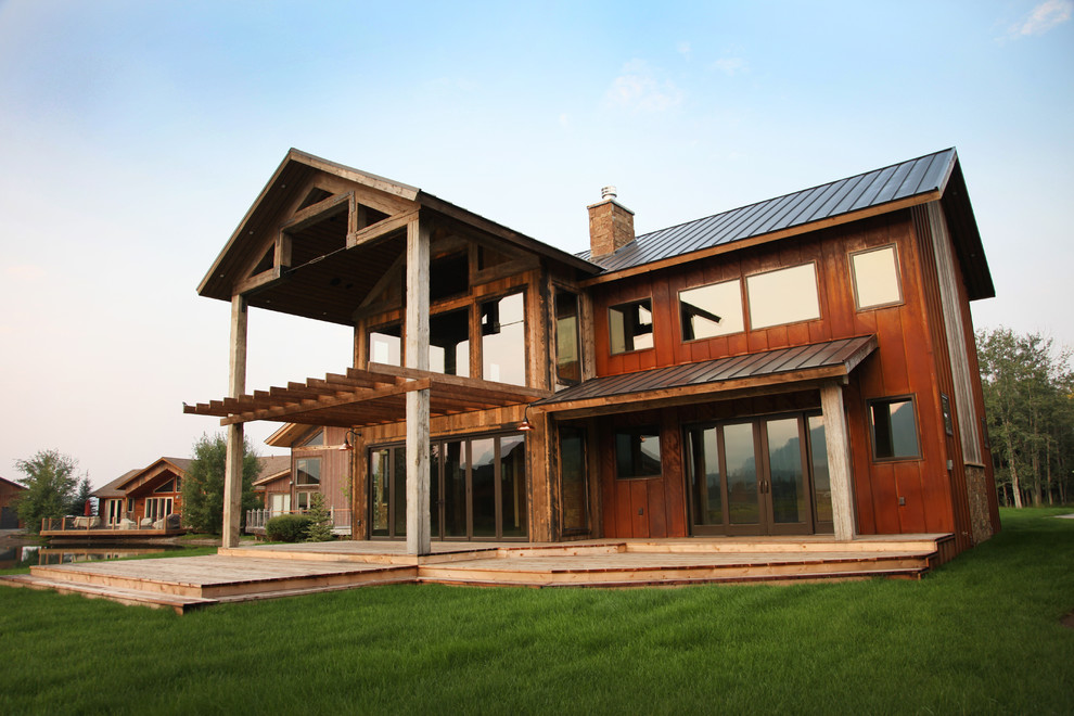 Mountain style brown two-story mixed siding gable roof photo with a metal roof