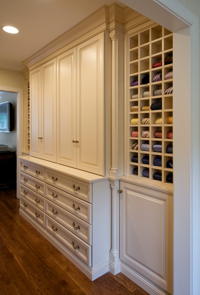 Inspiration for an expansive traditional men's walk-in wardrobe in Philadelphia with raised-panel cabinets, white cabinets and light hardwood floors.