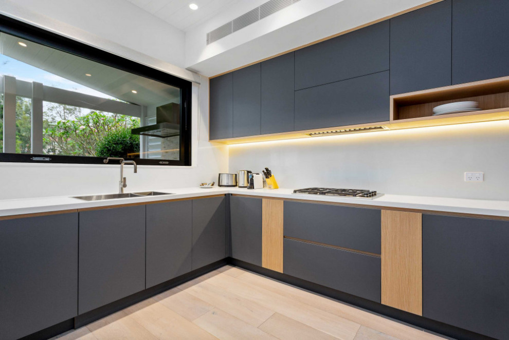 This is an example of a beach style kitchen in Sydney.