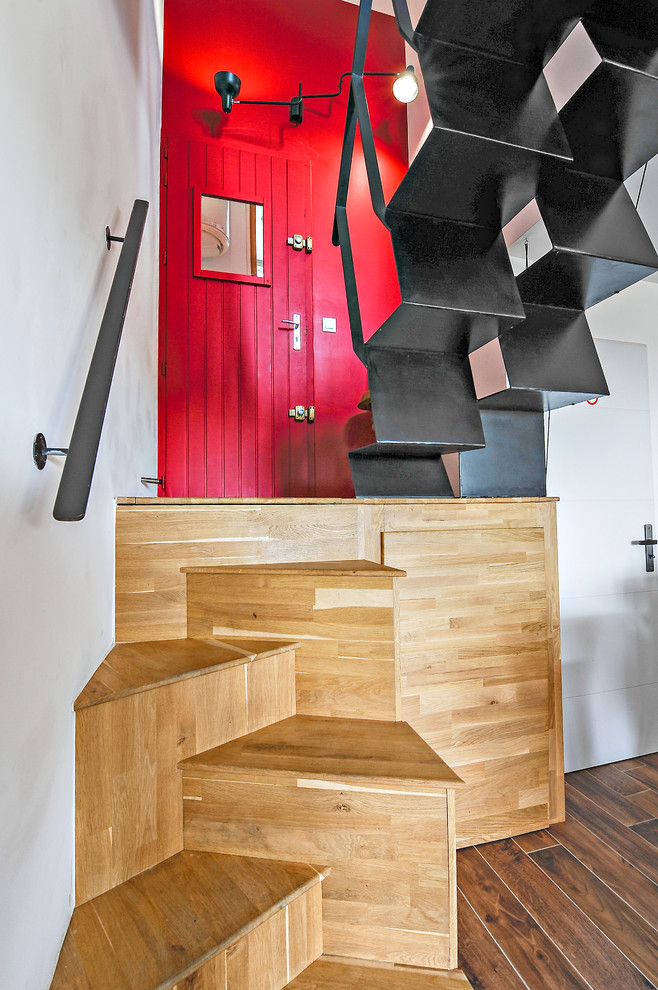 This is an example of a small contemporary wood curved staircase in Other with wood risers and metal railing.