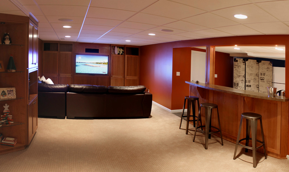 This is an example of a mid-sized modern fully buried basement in Cleveland with orange walls, carpet and no fireplace.