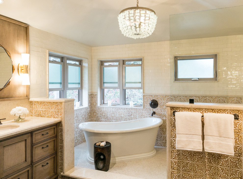 This is an example of a mediterranean master bathroom with a freestanding tub, orange tile, white walls, white floor, recessed-panel cabinets, dark wood cabinets, an open shower, ceramic tile, a console sink, an open shower, white benchtops, mosaic tile floors and engineered quartz benchtops.