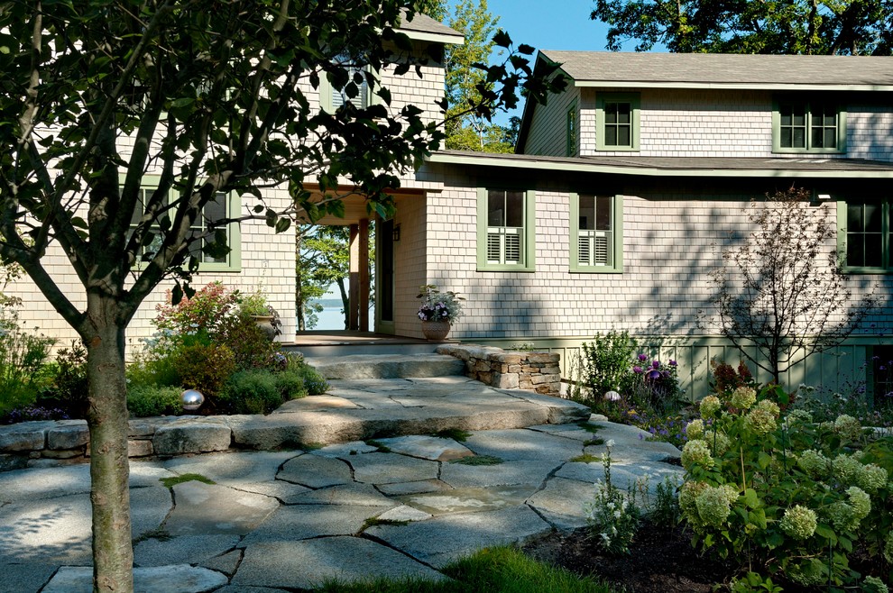 Design ideas for a beach style two-storey exterior in Portland Maine with wood siding.