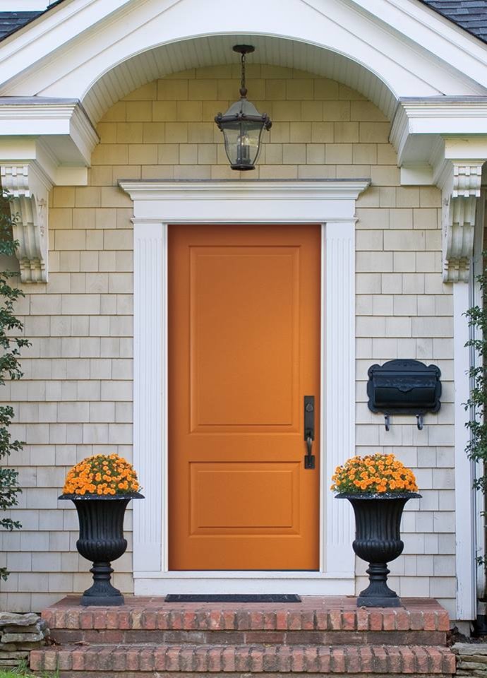 Example of a mid-sized transitional front door design in Omaha with beige walls and an orange front door