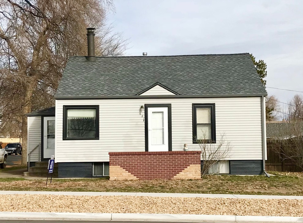 This is an example of a small traditional one-storey white house exterior in Denver with a gable roof and a shingle roof.