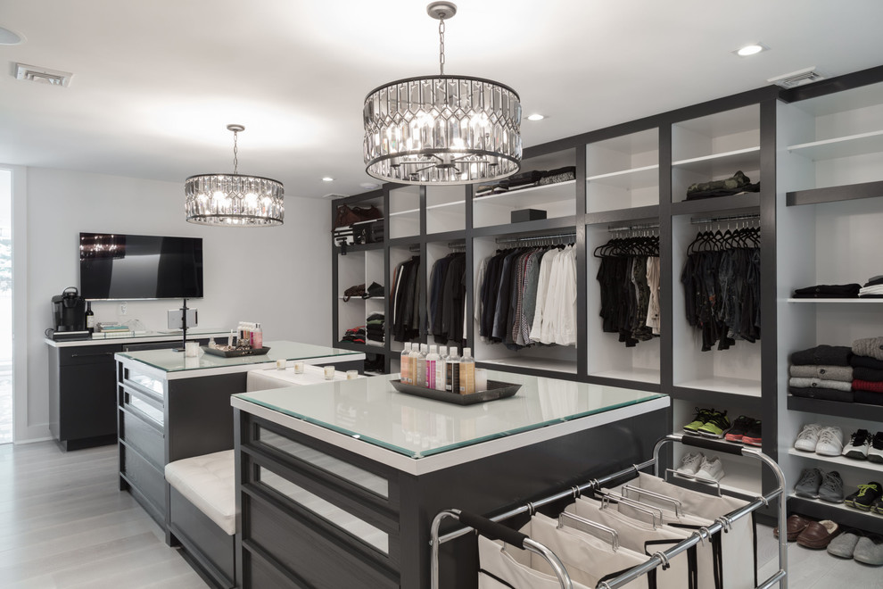Example of a trendy gender-neutral gray floor dressing room design in New York with open cabinets