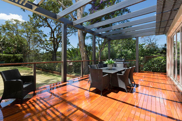 Contemporary backyard deck in Sydney with a pergola.