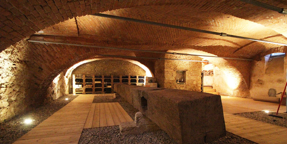 Photo of an expansive traditional wine cellar in Other with display racks.