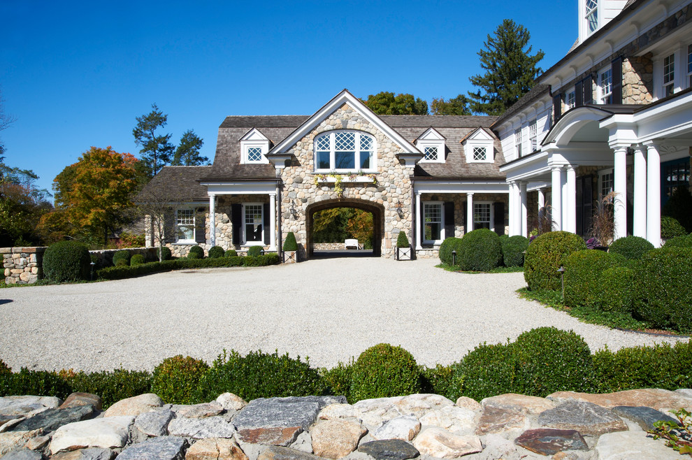 This is an example of a traditional three-storey exterior in New York with stone veneer.