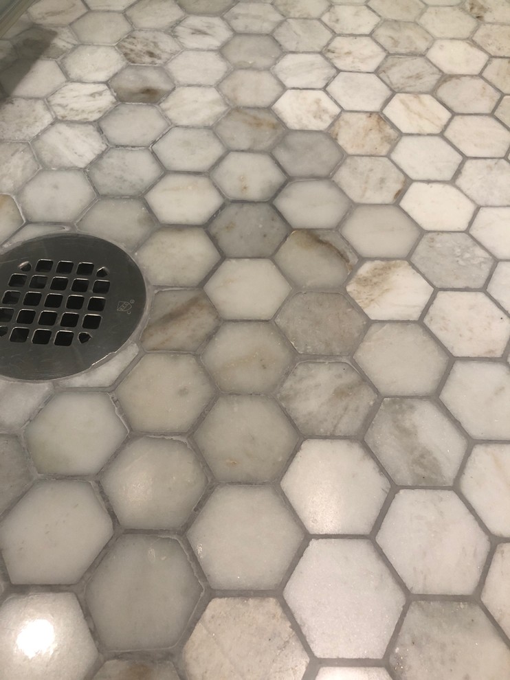 Discolored marble shower floor