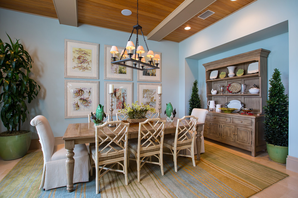 This is an example of a beach style dining room in Miami with blue walls and no fireplace.