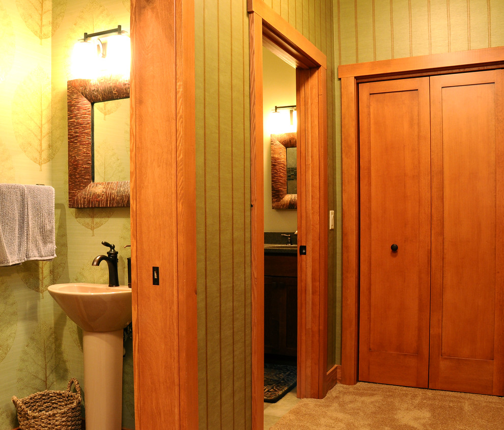 Example of a small mountain style master travertine floor freestanding bathtub design with green walls