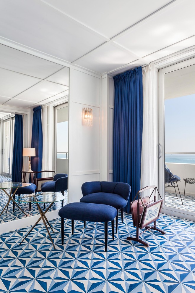 Photo of a large midcentury study room in Miami with white walls, ceramic floors, no fireplace, a freestanding desk and blue floor.