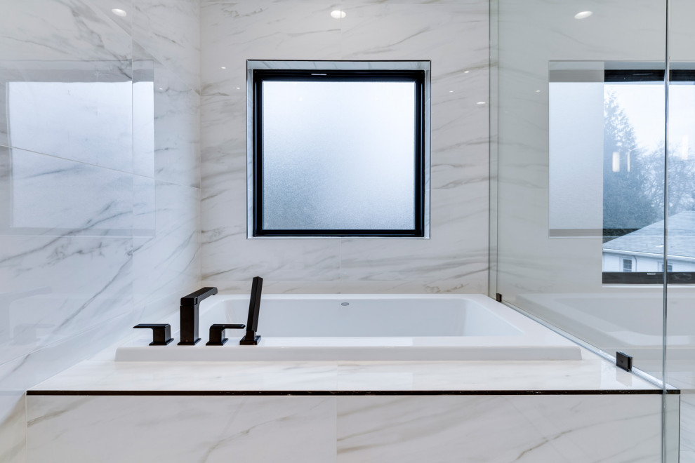 Photo of a mid-sized modern master bathroom in Other with a drop-in tub, a shower/bathtub combo, white tile, white walls, marble floors, an undermount sink, granite benchtops, white floor, a hinged shower door, white benchtops, a double vanity and a built-in vanity.