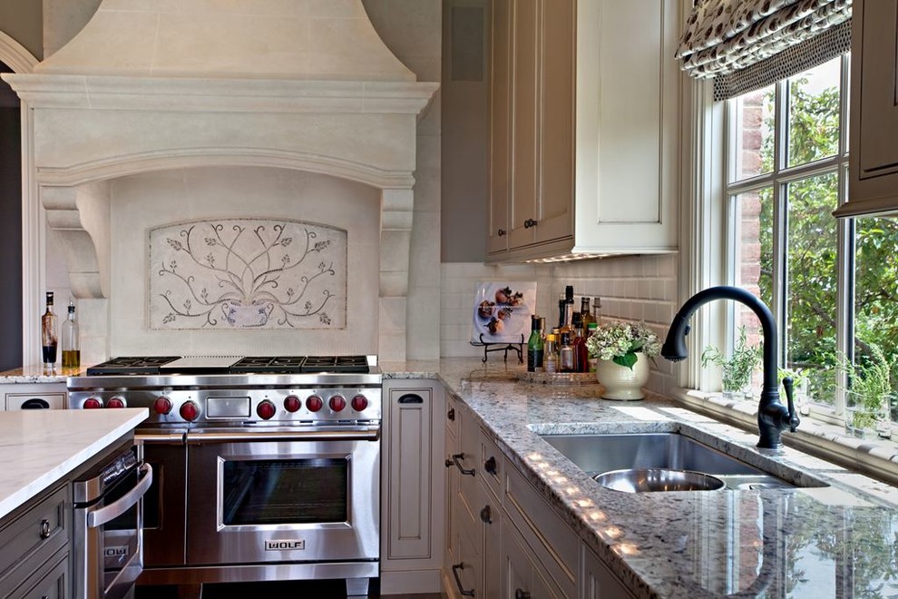 Large transitional l-shaped dark wood floor kitchen pantry photo in Denver with an undermount sink, shaker cabinets, white cabinets, laminate countertops, white backsplash, subway tile backsplash, stainless steel appliances and an island