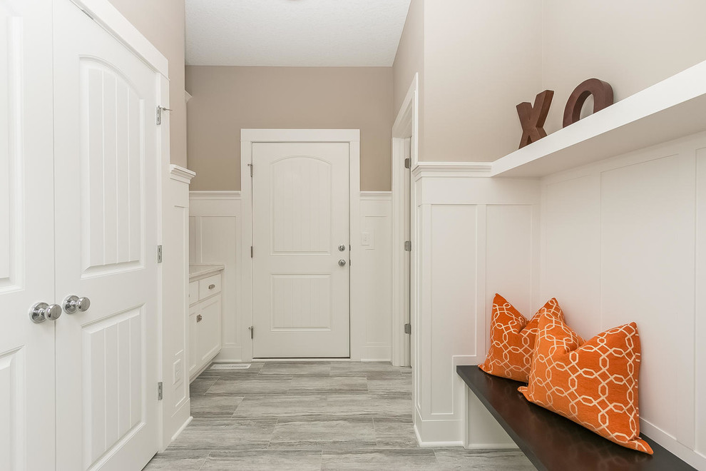 Traditional mudroom in Minneapolis with beige walls, linoleum floors, a single front door and a white front door.