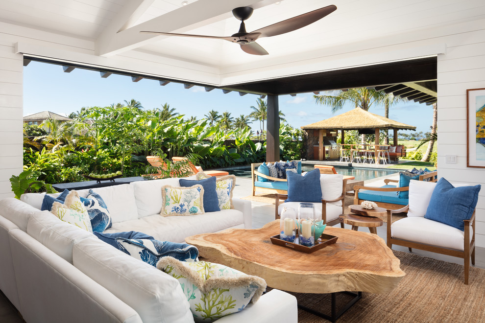 This is an example of a mid-sized beach style open concept living room in Hawaii with white walls, ceramic floors, no fireplace, a built-in media wall and grey floor.