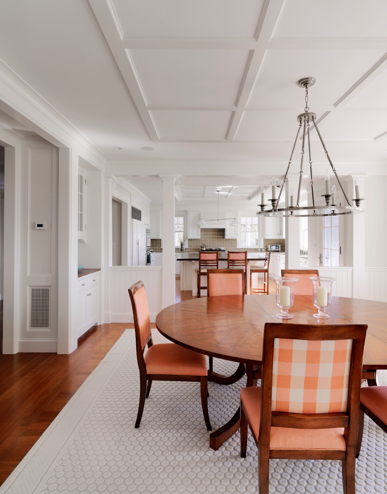 Traditional dining room in Boston with white walls and dark hardwood floors.