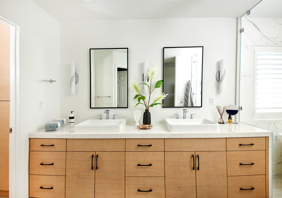 Photo of a medium sized modern ensuite wet room bathroom in Denver with flat-panel cabinets, light wood cabinets, a freestanding bath, a one-piece toilet, white tiles, porcelain tiles, white walls, porcelain flooring, a vessel sink, engineered stone worktops, grey floors, a hinged door, white worktops, a wall niche, double sinks and a built in vanity unit.