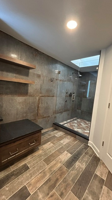Example of a mid-sized mountain style bathroom design with recessed-panel cabinets, dark wood cabinets and a built-in vanity
