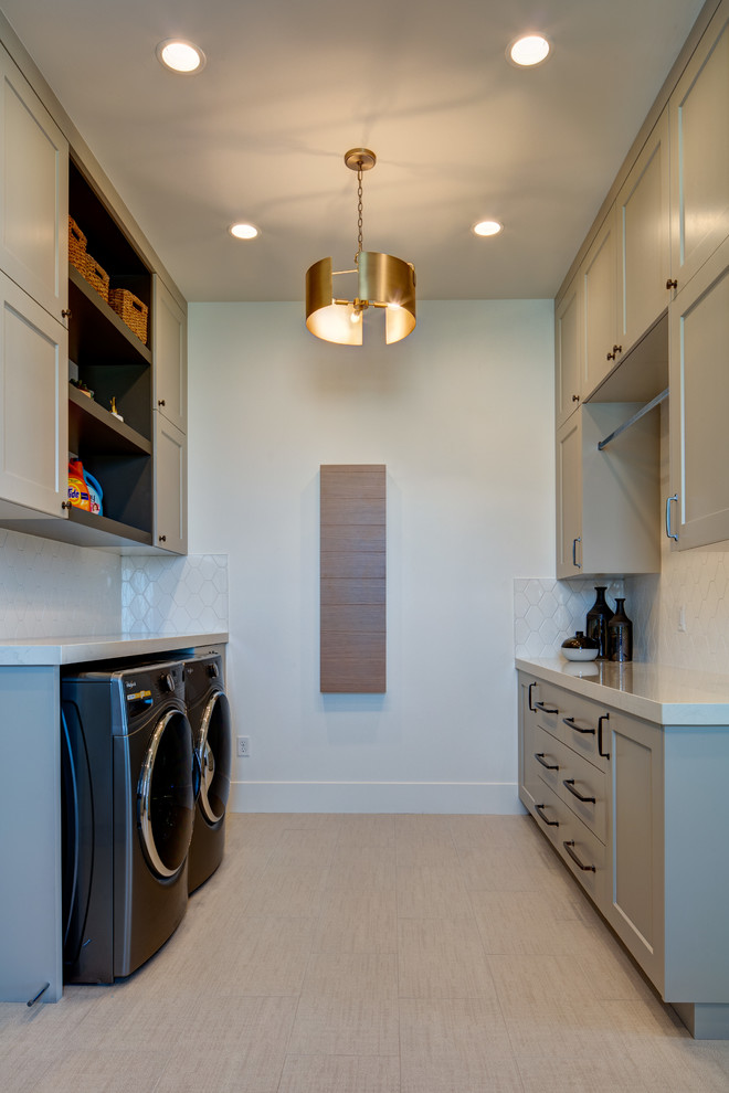 Design ideas for a mid-sized contemporary galley dedicated laundry room in Salt Lake City with white walls, ceramic floors, shaker cabinets, beige cabinets, quartz benchtops, a side-by-side washer and dryer, beige floor and white benchtop.