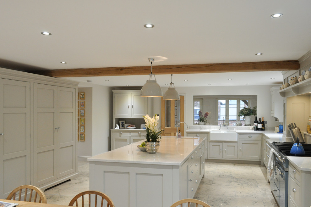 Inspiration for an expansive traditional l-shaped open plan kitchen in Other with a farmhouse sink, shaker cabinets, grey cabinets, quartzite benchtops, coloured appliances, limestone floors and with island.