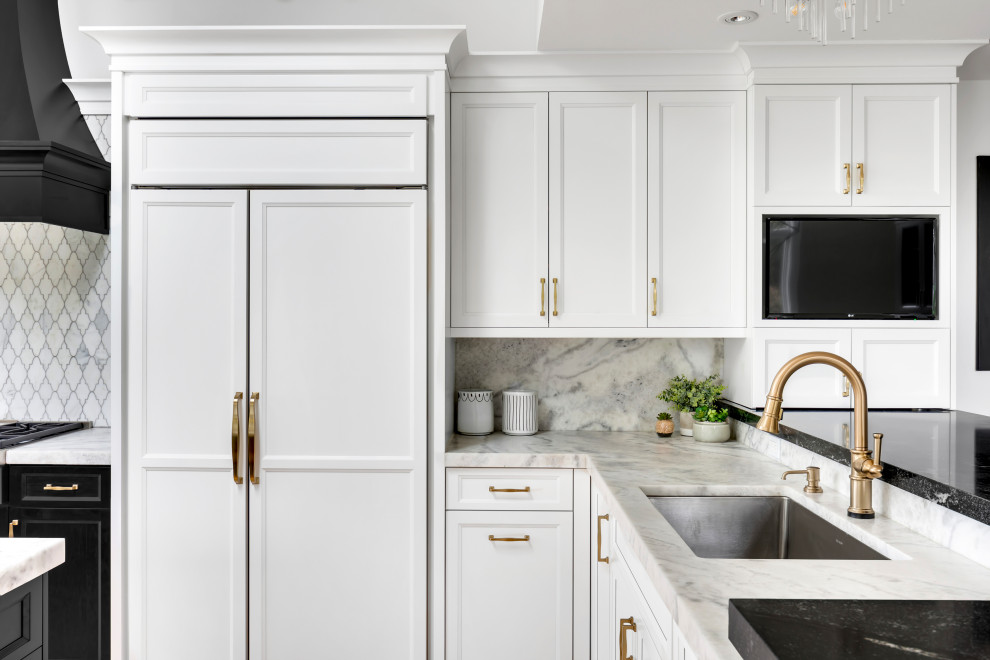 Large transitional l-shaped light wood floor, beige floor and vaulted ceiling eat-in kitchen photo in New York with an undermount sink, shaker cabinets, white cabinets, quartz countertops, white backsplash, marble backsplash, paneled appliances, an island and white countertops