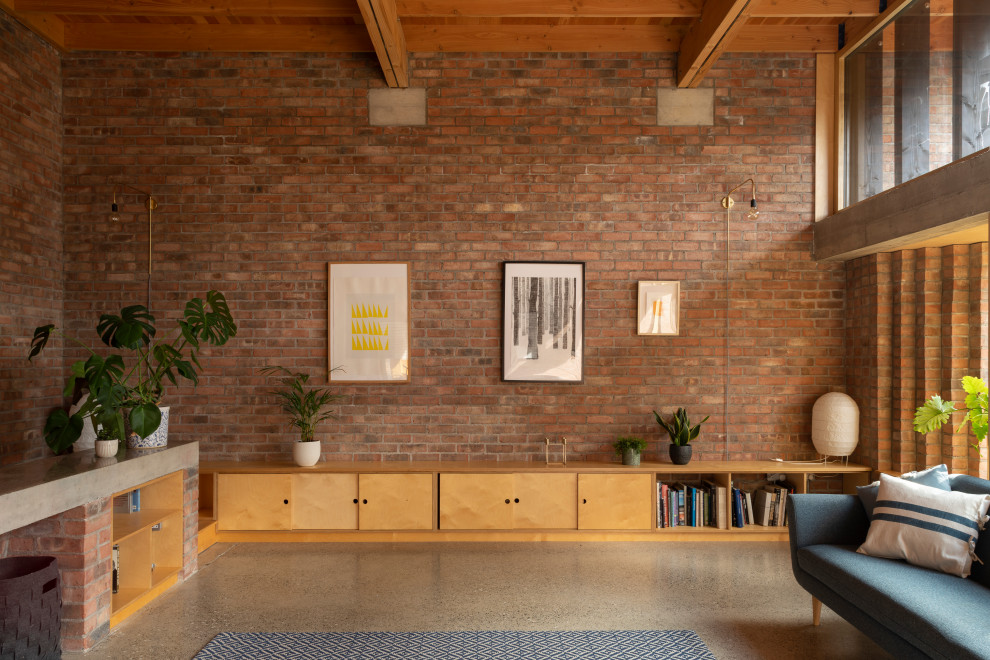 Large contemporary formal open plan living room in Other with concrete flooring, a wood burning stove, a brick fireplace surround, a built-in media unit, grey floors, a coffered ceiling and brick walls.