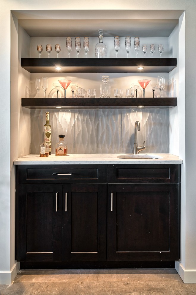 Photo of a large contemporary u-shaped home bar in Other with an integrated sink, recessed-panel cabinets, brown cabinets, quartz benchtops, multi-coloured splashback, ceramic splashback, ceramic floors and beige floor.